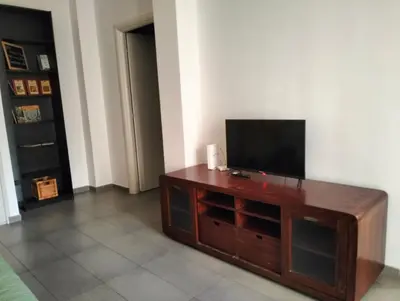 a living room with a flat screen tv on a wooden entertainment center at Appartamento Monteverde in Rome