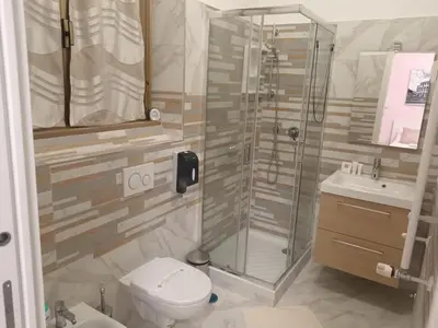 a bathroom with a shower and a toilet and a sink at B&B VIKTORIA in Rome