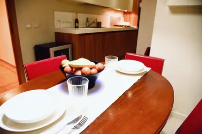 a wooden table with a bowl of food on it at Chic and Elegant Apartment in the heart of Rome in Rome
