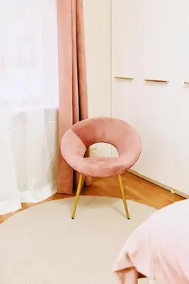 a pink chair sitting on a rug in a bedroom at Chic and Elegant Apartment in the heart of Rome in Rome