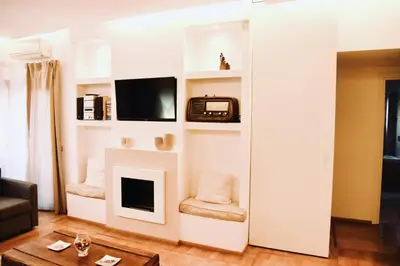 a living room with a fireplace and a tv at Chic and Elegant Apartment in the heart of Rome in Rome