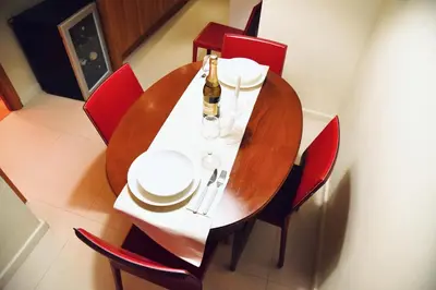 a dining room table with a bottle of wine on it at Chic and Elegant Apartment in the heart of Rome in Rome