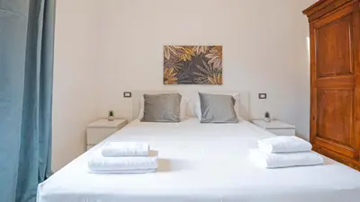 a bedroom with a large white bed with two pillows at EasyTopStay - Colonna Guest House in Rome