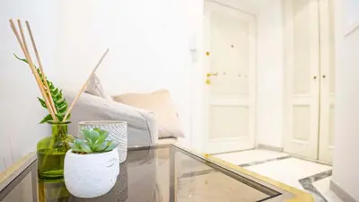a room with a glass table with two vases and a couch at EasyTopStay - Colonna Guest House in Rome