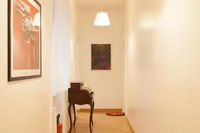 a hallway with a table and a painting on the wall at Cicerone 60 in Rome
