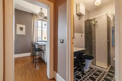 a bathroom with a shower and a sink and a table at GuestHost - Roma Termini Lovely Apartment in Rome