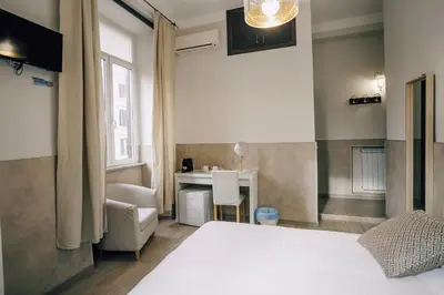 a hotel room with a bed and a desk at Mirabilia House in Rome