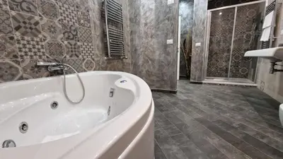 a large bathroom with a tub and a shower at Major 93 Guesthouse in Rome