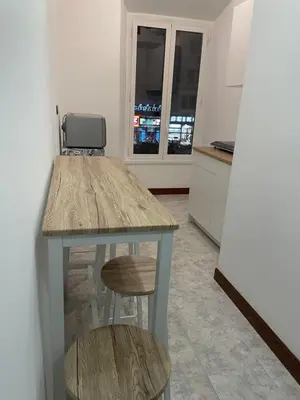 a kitchen with a table and two stools at Blue Vatican House in Rome