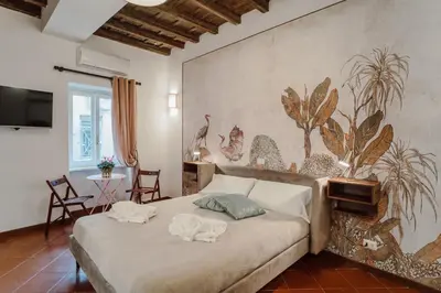a bedroom with a bed with two animal pillows on it at La Maisonette di Trastevere in Rome