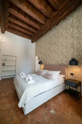 a bedroom with a large white bed with two teddy bears on it at Campo De Fiori Home in Rome