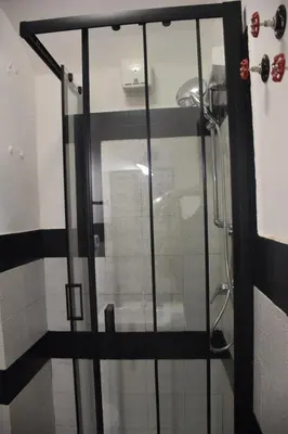 a glass shower door in a bathroom at DOMUS LAURA Rione MONTI in Rome