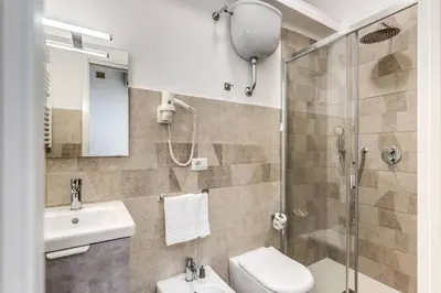 a bathroom with a shower and a toilet and a sink at New flat in front StPeter Square in Rome