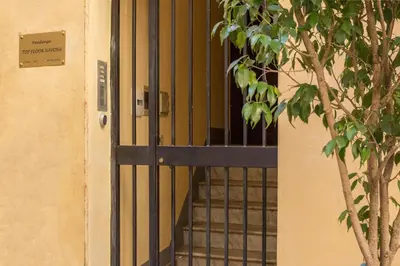 a black door with a window and a tree at Top Floor Navona in Rome