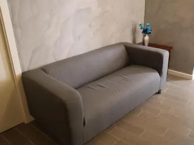 a gray couch in a room with a wall at Top Floor Navona in Rome