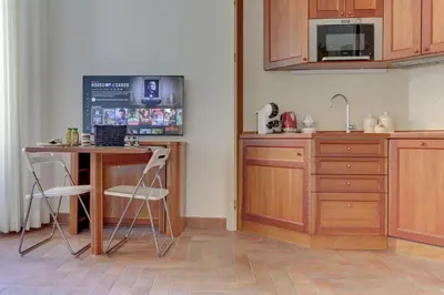 a kitchen with a counter and a table and a counter top at Home and More St. Angelo APT 5 in Rome