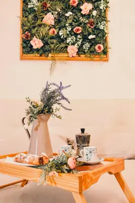 a table with a vase and tea cups on it at Golden Luxury Home - San Giovanni - 3 min to Colosseum in Rome