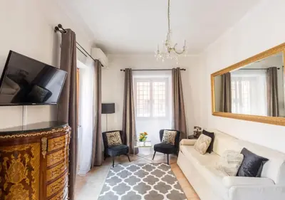 a living room with a couch and a mirror at Navona Home in Rome