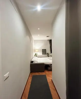 a hallway leading to a bedroom with a bed at Sopi Vatican Suite Apartment in Rome