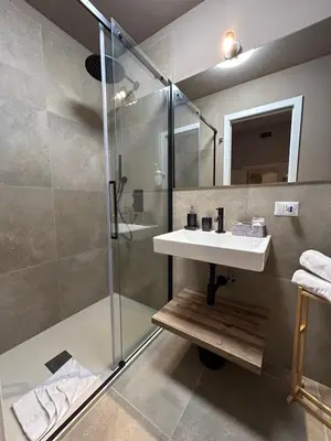 a bathroom with a sink and a shower at Sopi Vatican Suite Apartment in Rome