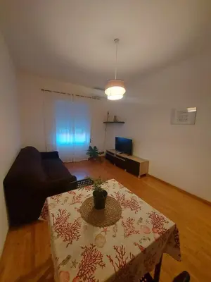a living room with a table and a couch at VATICAN PITTORE HOUSE in Rome