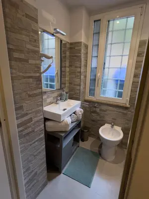 a bathroom with a sink and a toilet at Trithome Suite Boutique Barberini in Rome