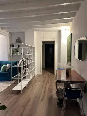a living room with a blue couch and a table at Trithome Suite Boutique Barberini in Rome