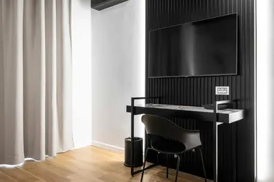 a black desk with a television and a chair at Home at Rome Luxury Navona Guest House 2 in Rome