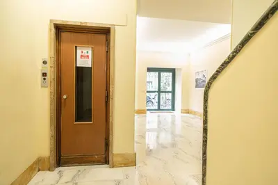 a hallway with a wooden door in a building at Diamond Vatican Apartment in Rome