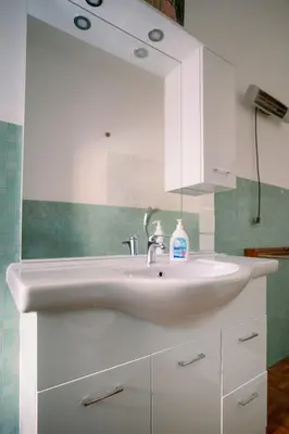 a bathroom with a white sink and a mirror at Villa Fiorelli rooms in Rome