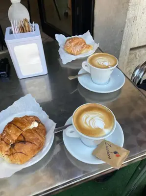 two cups of coffee and pastries on a table at Appartamento 5 stelle in Piazza Asti - Re di Roma - in Rome