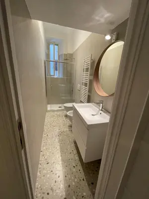 a bathroom with a sink and a toilet and a mirror at Civitas Leonina Apartment in Rome