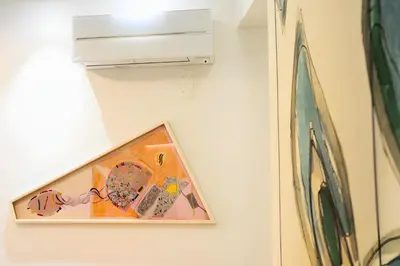 a picture hanging on a wall with a painting at The Best Nest - Home Suite Home NEW OPENING in Rome