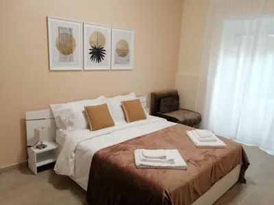 a bedroom with a large bed with towels on it at San Pietro Happy Home in Rome