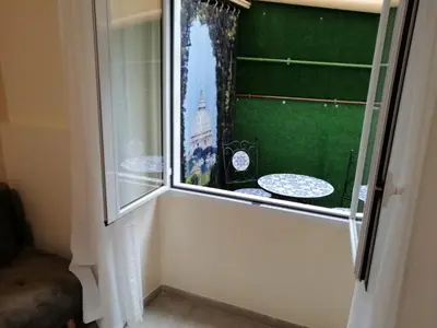 a window in a room with a green wall at San Pietro Happy Home in Rome