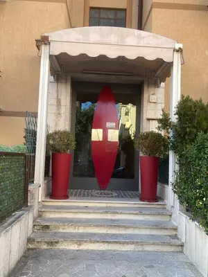 a red surfboard in the entry of a house at San Pietro Happy Home in Rome