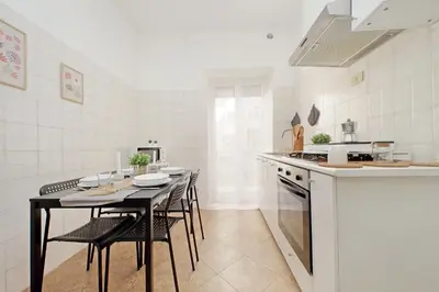 a kitchen with a table and chairs and a counter at A Casa di Domenico in Rome
