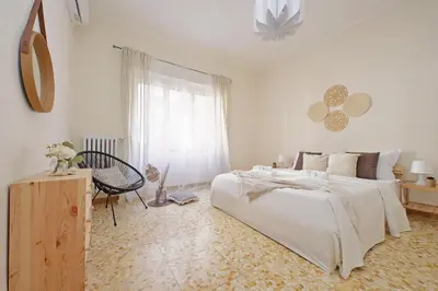 a white bedroom with a large bed and a window at A Casa di Domenico in Rome