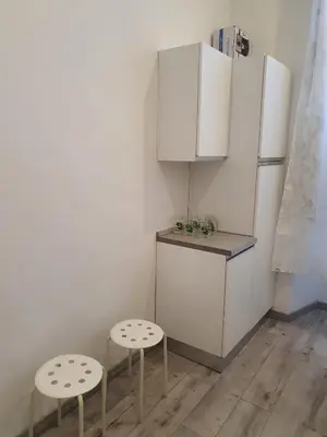 a kitchen with two stools and a refrigerator at Casa Max in Rome