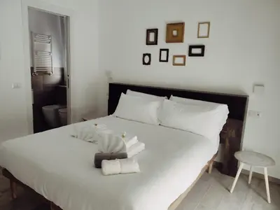 a bedroom with a white bed with towels on it at Bagnera51 in Rome