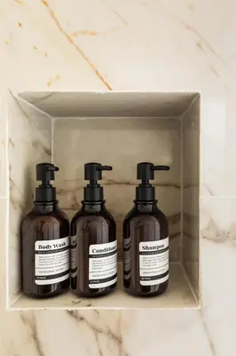 three bottles of soap in a box on a counter at Terrace Boutique Apartment - Dolce Vita in Rome
