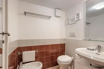 a bathroom with a white toilet and a sink at Lungaretta Studio Flat [trastevere] in Rome