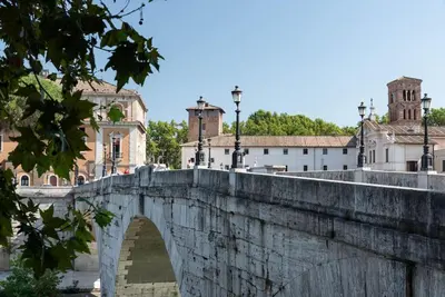 a bridge over a river with buildings in the background at Lungaretta Studio Flat II (Trastevere) in Rome