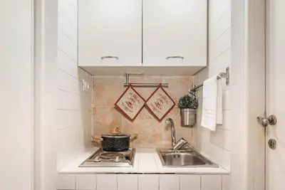 a kitchen with a sink and a stove at Lungaretta Studio Flat II (Trastevere) in Rome