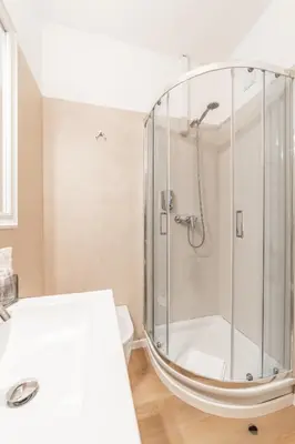 a bathroom with a shower with a glass enclosure at Maison Macao - Golden Keys Collection in Rome