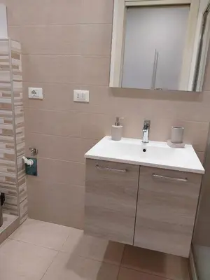 a bathroom with a sink and a mirror at Il covo dei Briganti in Rome
