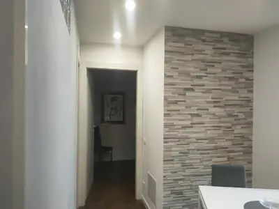 a hallway with a brick accent wall in a house at Il covo dei Briganti in Rome