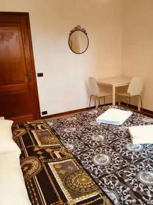 a bedroom with a bed and a table and a table and chairs at San Giovanni Apartment in Rome