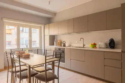 a kitchen with a table and some chairs and a table and a kitchen with at Marisa Home in Rome