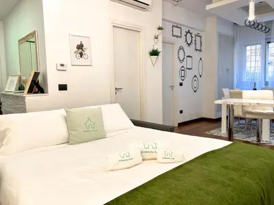 a white bed with two pillows on it in a room at UNIQUE House - 3 Bedrooms & 2 Bathrooms with 4 Beds - 100 meters to the Metro A in Rome